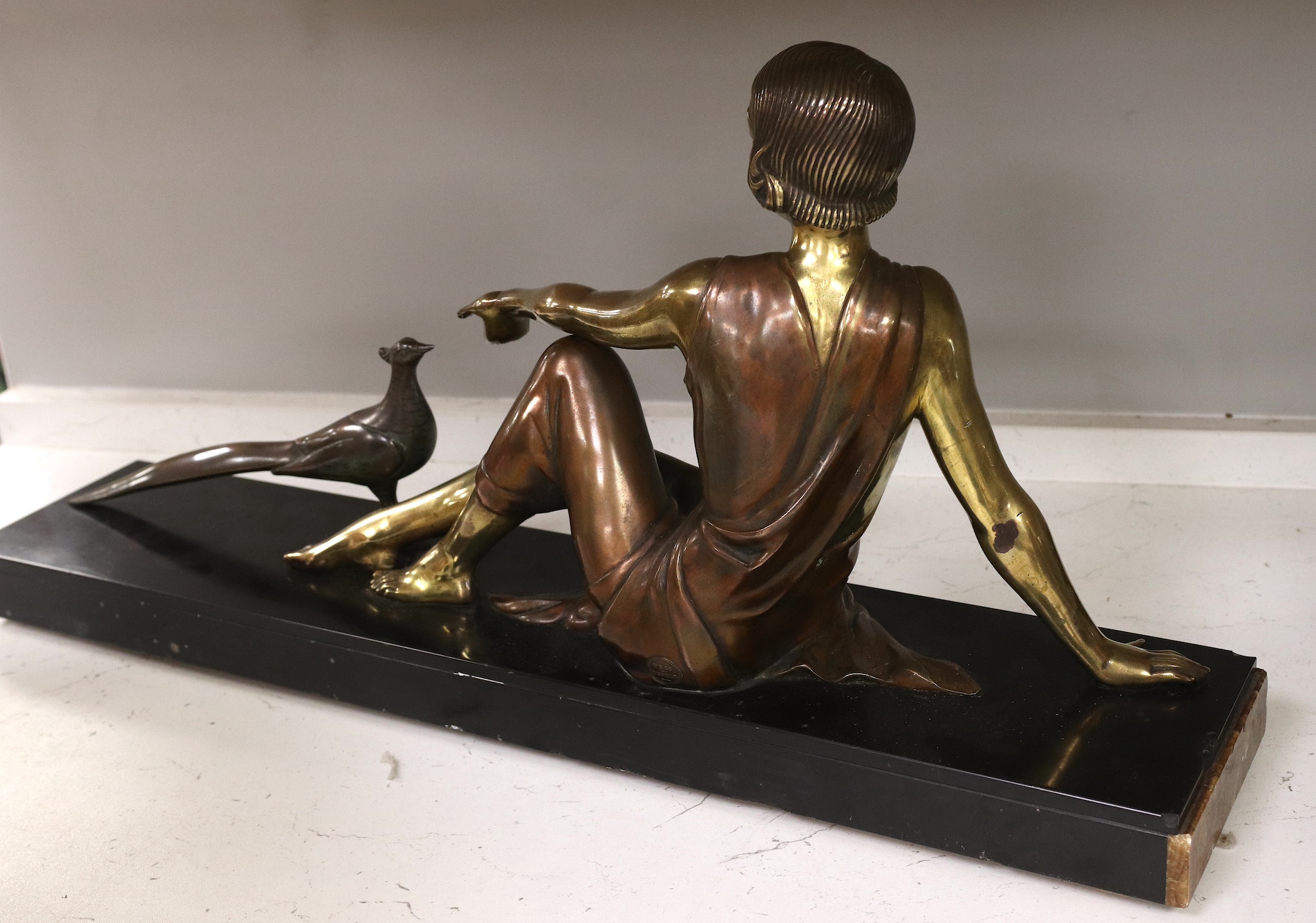 An Art Deco figural bronze of a girl with a peacock, VRAI Bronze foundry mark, signed Godard, on a marble base, base 65cm long, 30cm high. Condition - fair to good